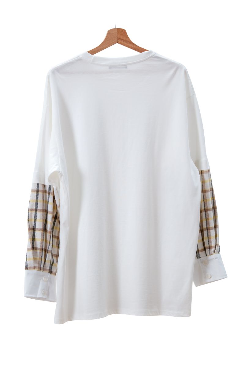 White long-sleeve shirt with plaid sleeves on a hanger against a white background