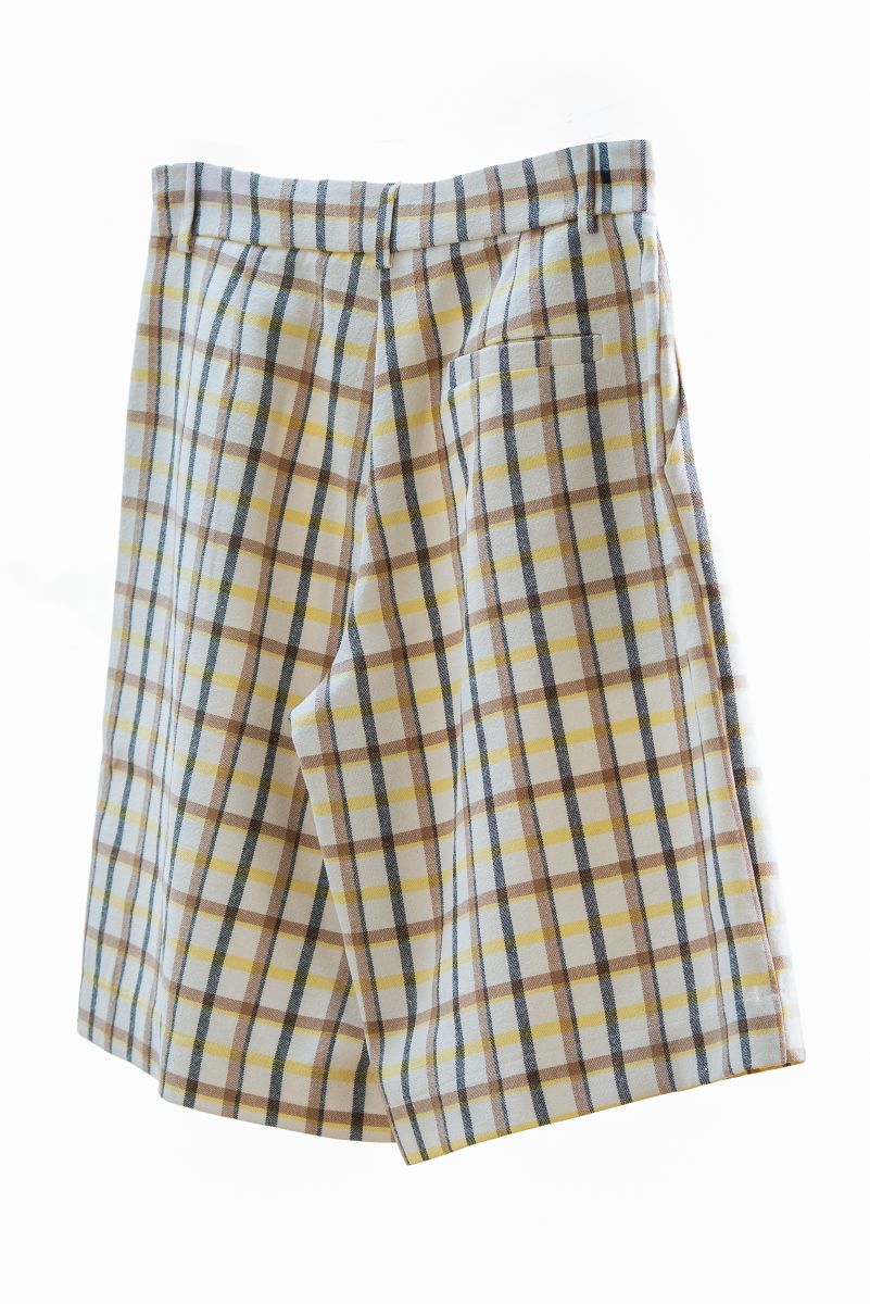 Plaid shorts with yellow and brown pattern on a white background