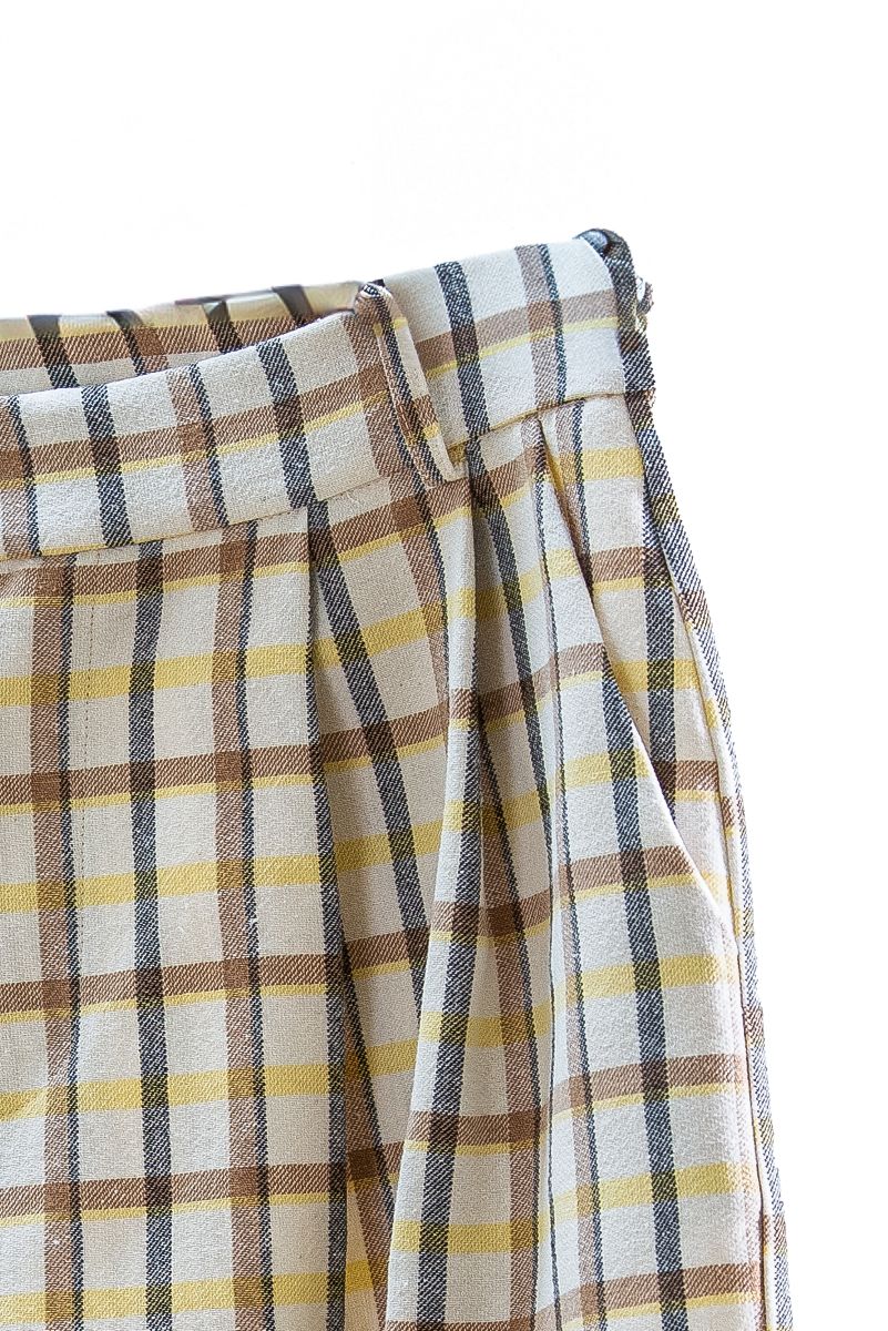 Plaid fabric with brown, yellow, and white colors on a white background