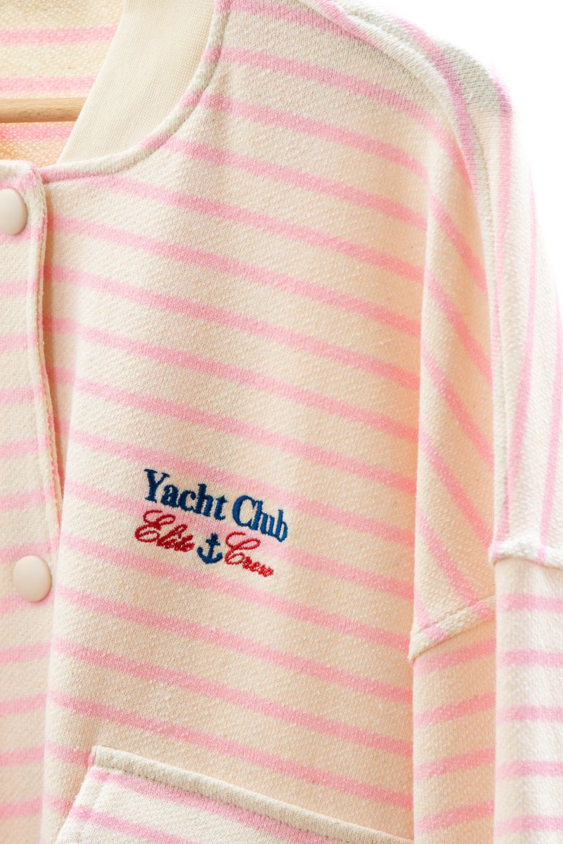 Pink and white striped garment with 'Yacht Club Elite Crew' embroidery on a white background