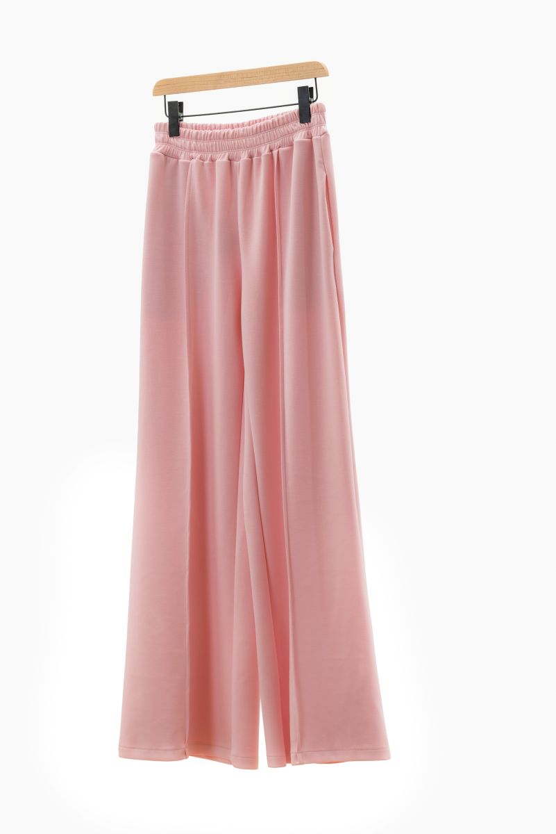 Pink wide-leg pants on a hanger against a white background