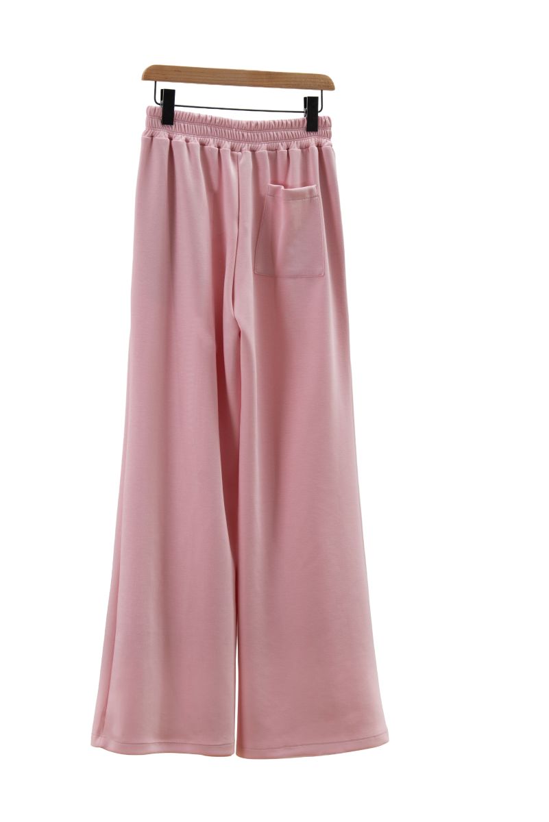 Pink wide-leg pants on a hanger against a white background