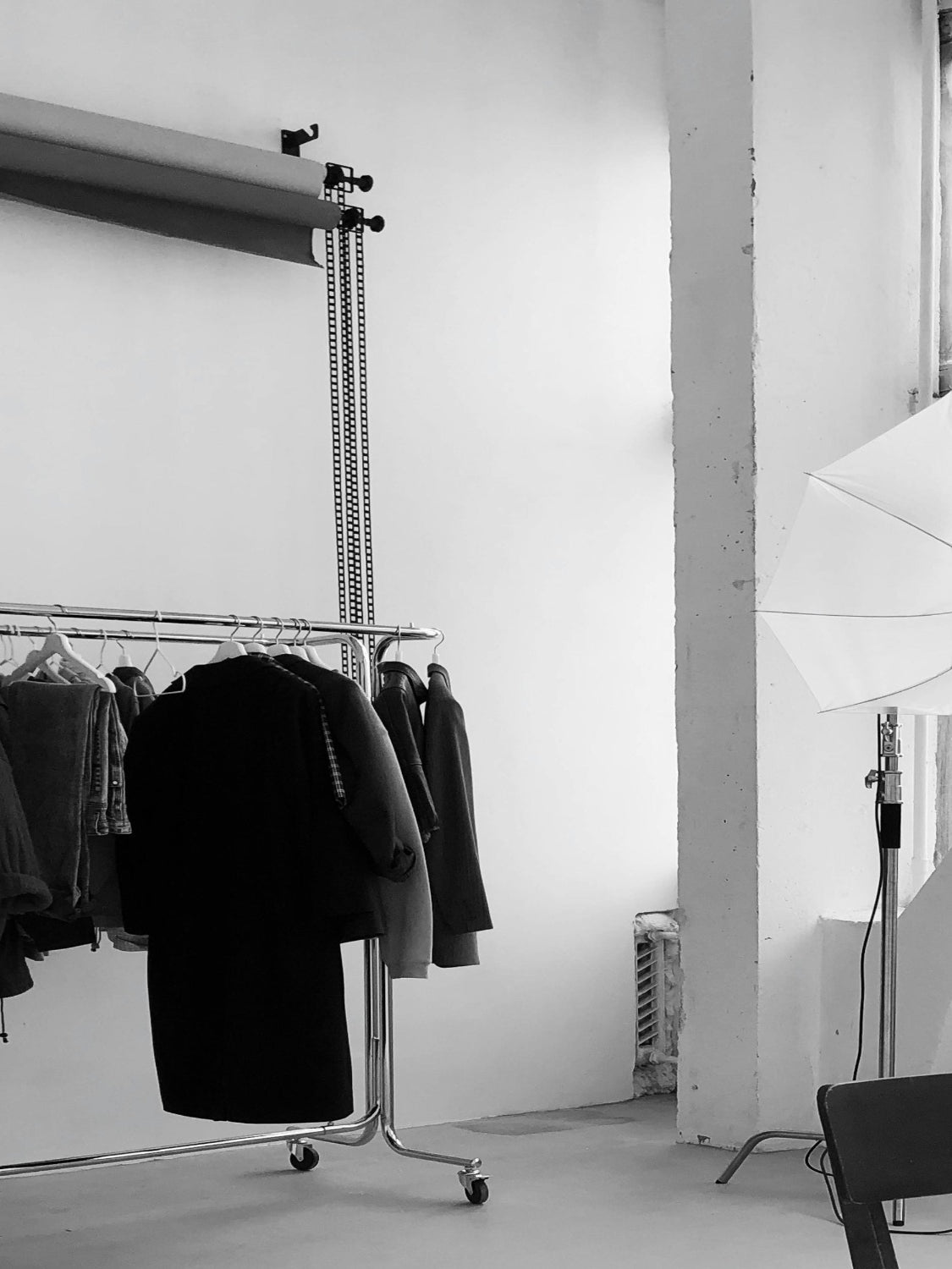Clothing rack with jackets in a minimalistic room.